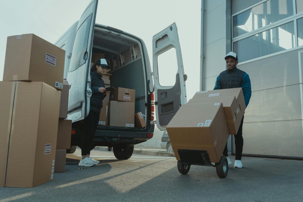 pexels-photo-6169668-6169668 Two couriers load boxes into a van for shipment, showcasing logistics and teamwork.